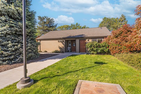 a house with a sidewalk and lawn in front of it