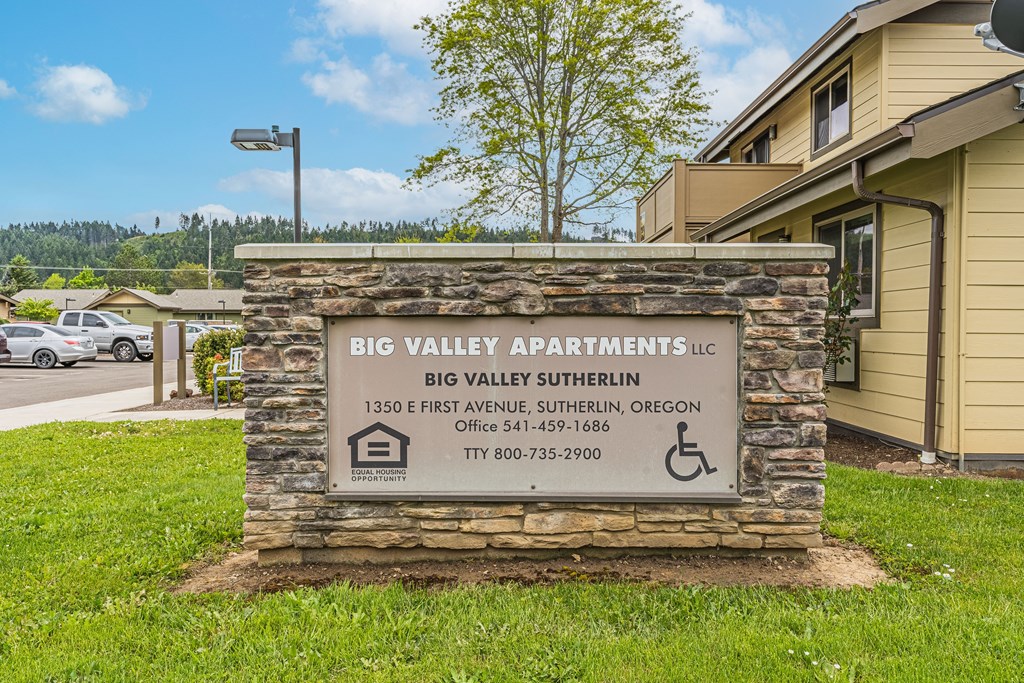 a building with a sign for big valley apartments