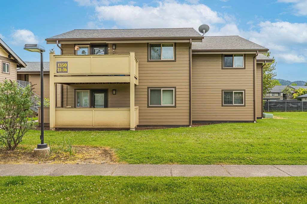 a yellow house with a sidewalk in front of it