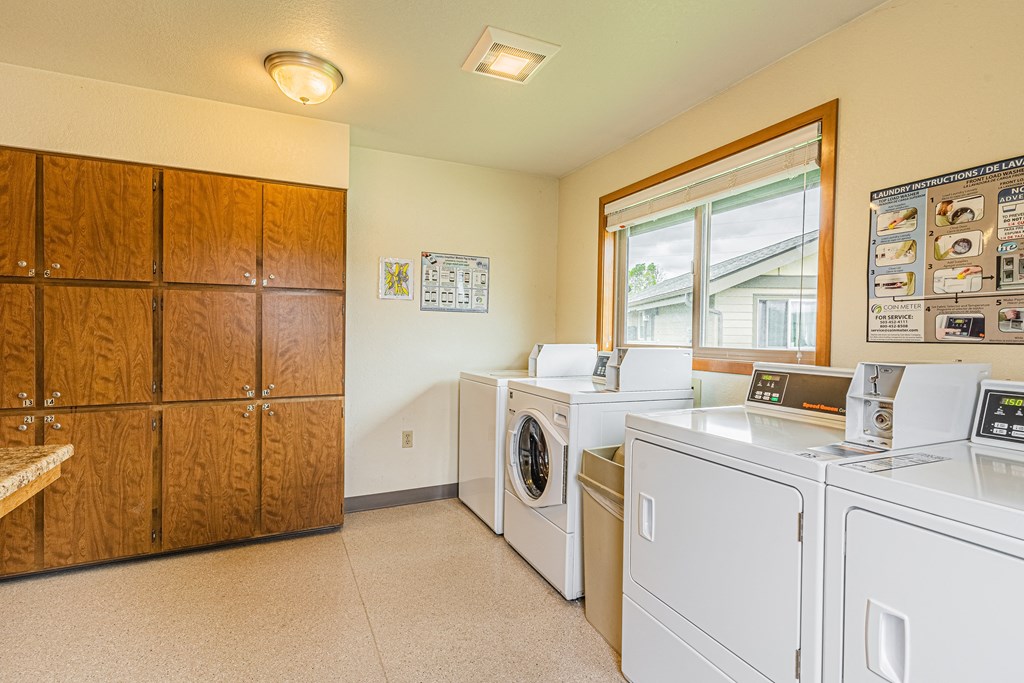 the laundry room is equipped with washes and dryers and a large window