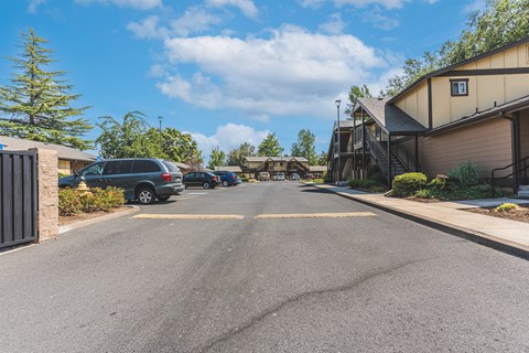 a street with houses and cars parked on the side of the road