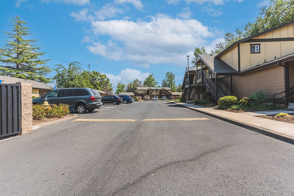 a street with houses and cars parked on the side of the road