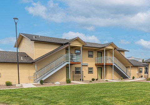 A two-story house with a balcony on the second floor.