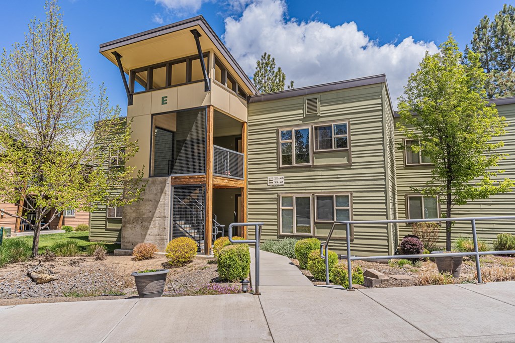 A two-story house with a balcony on the upper floor.