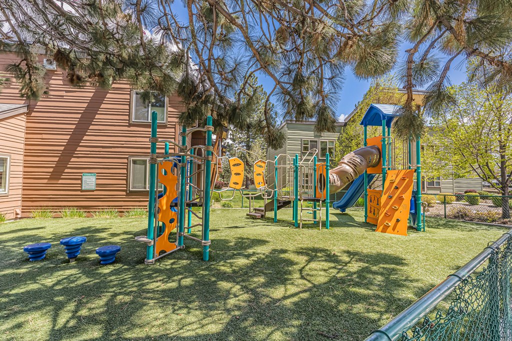 A playground with a slide, swings, and climbing structures.