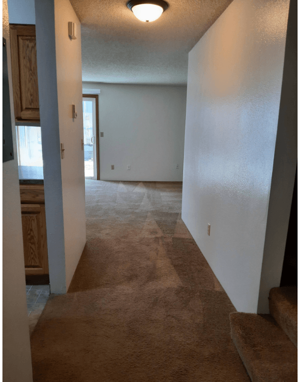 View of a living room looking into the kitchen entrance in a unit at Eagle Cap Pineview Apartments in Joseph, Oregon