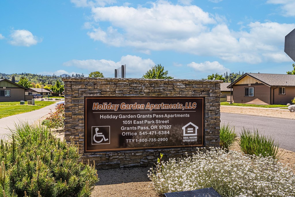 a sign for holiday apartments on the side of a road