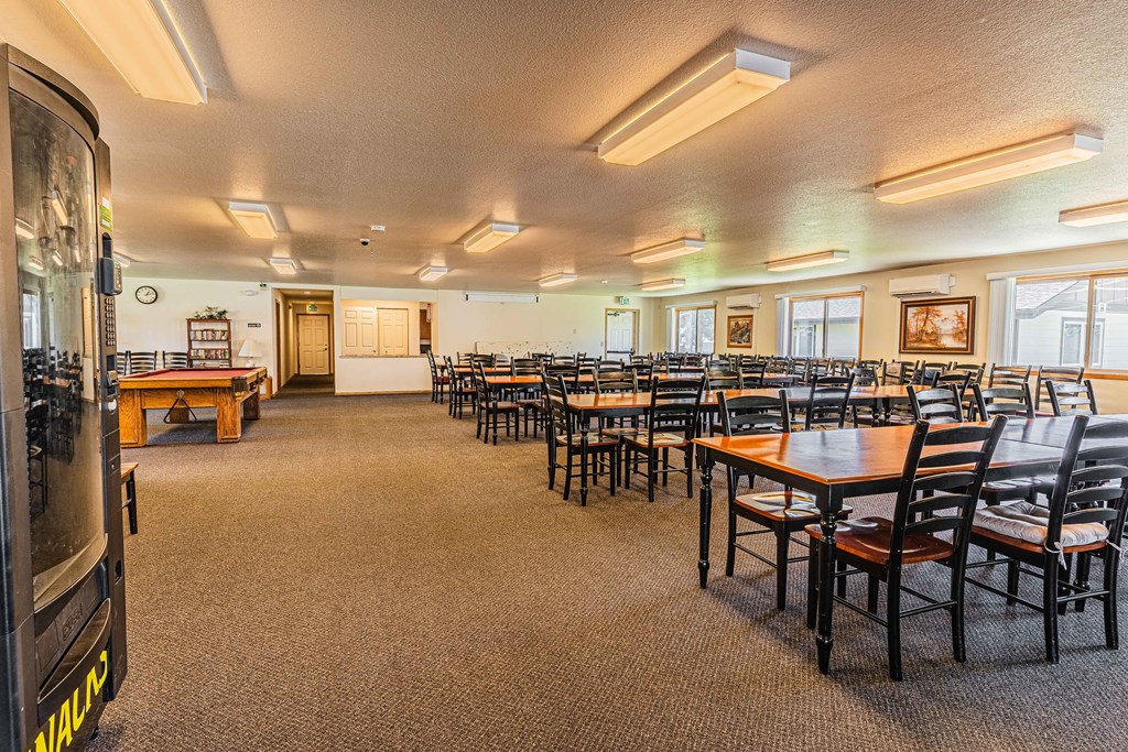 a dining room with tables and chairs and a pool table