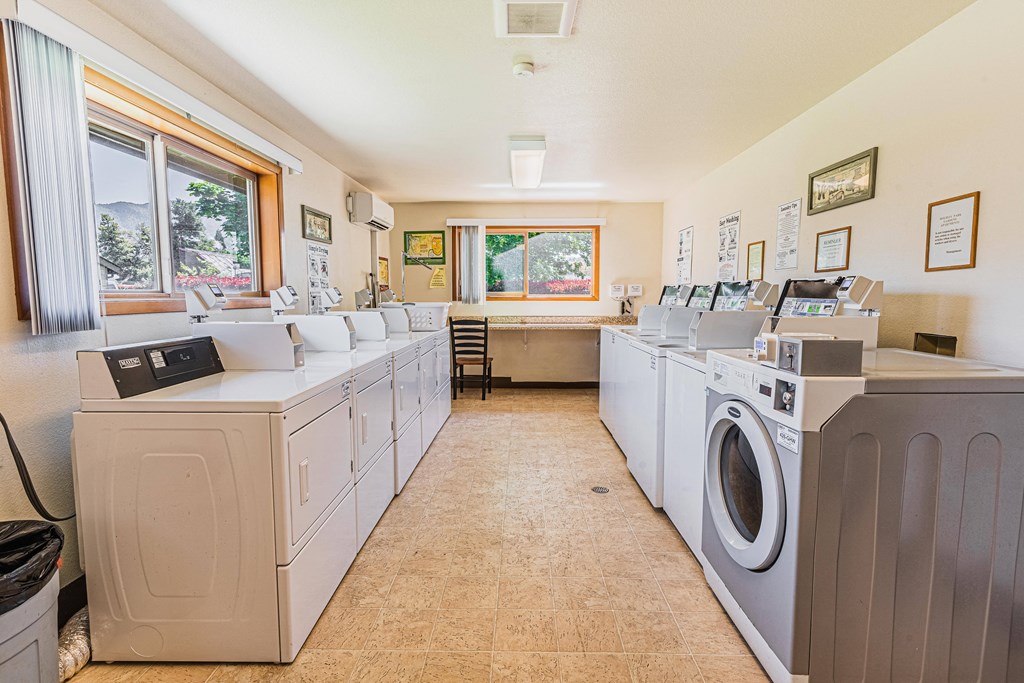 a washer and dryer laundry room with washes and washing machines and windows