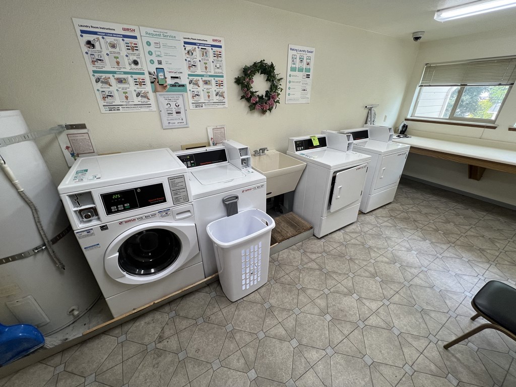 an image of a laundry room with washing machines and other appliances