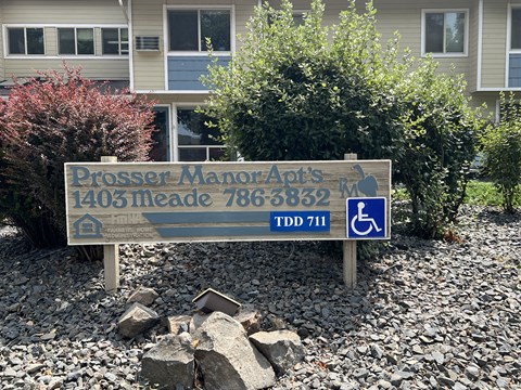 a sign in front of a house with a wheelchairaccessibleaccessible sign
