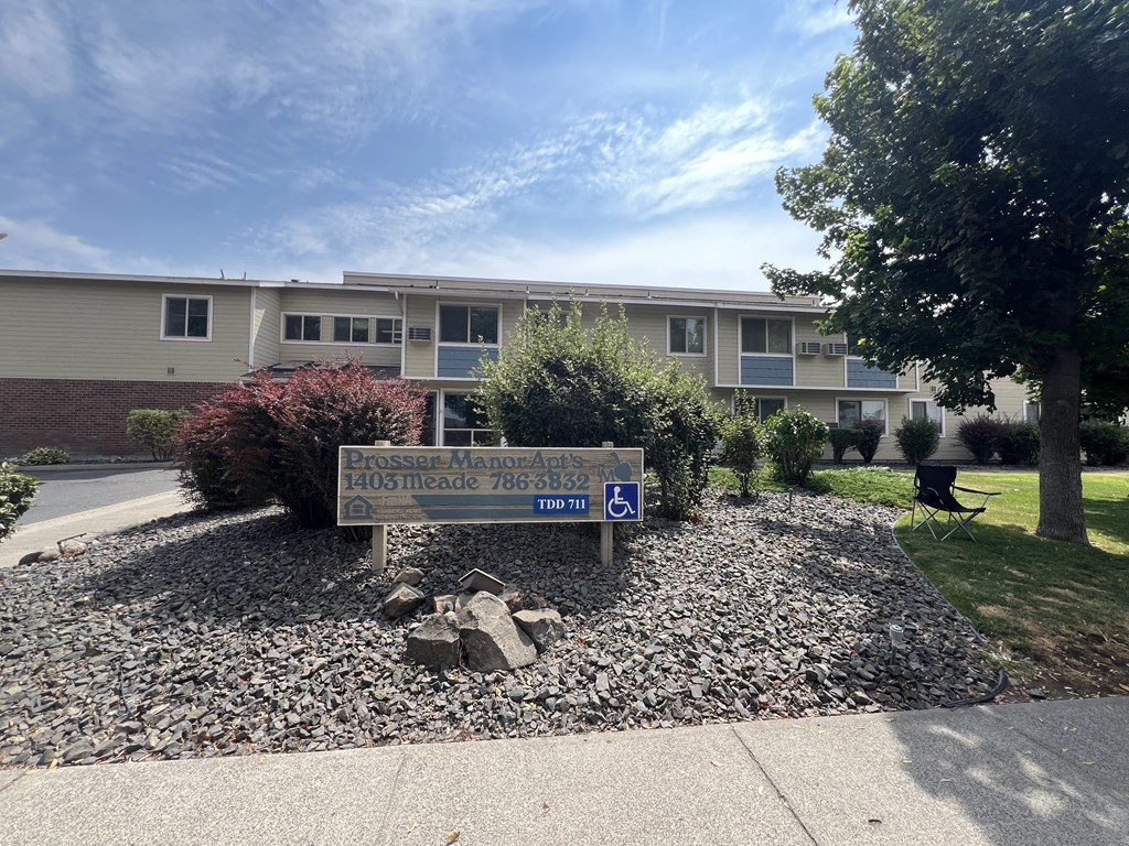 a sign in front of an apartment building