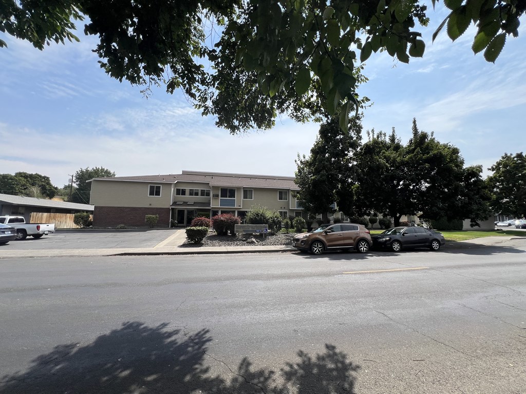 a parking lot in front of an apartment building