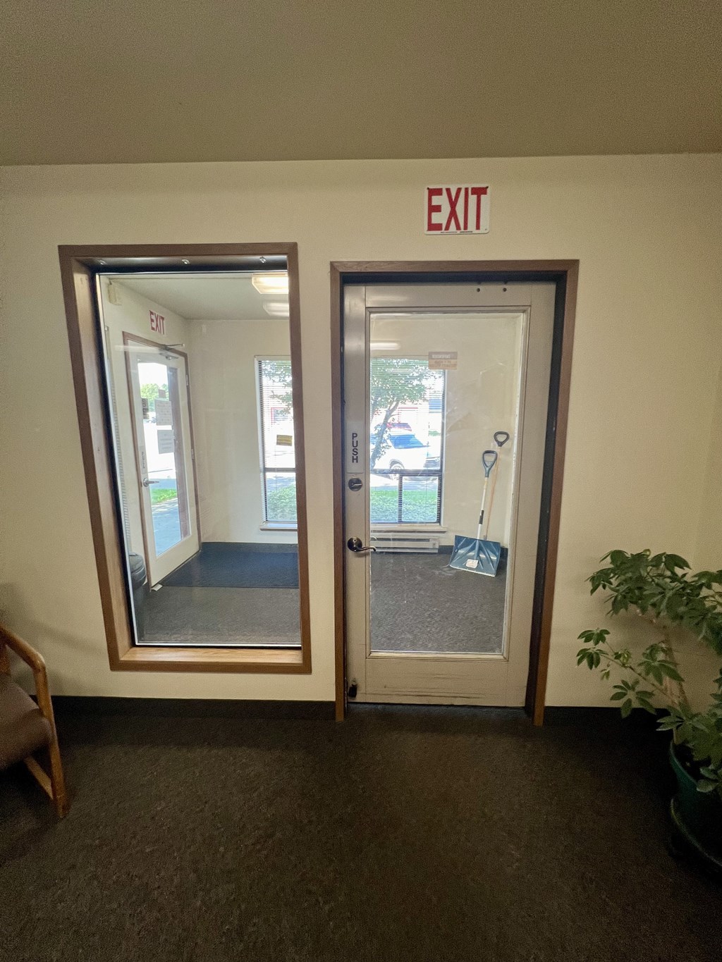 an exit door with an exit sign above it in an office