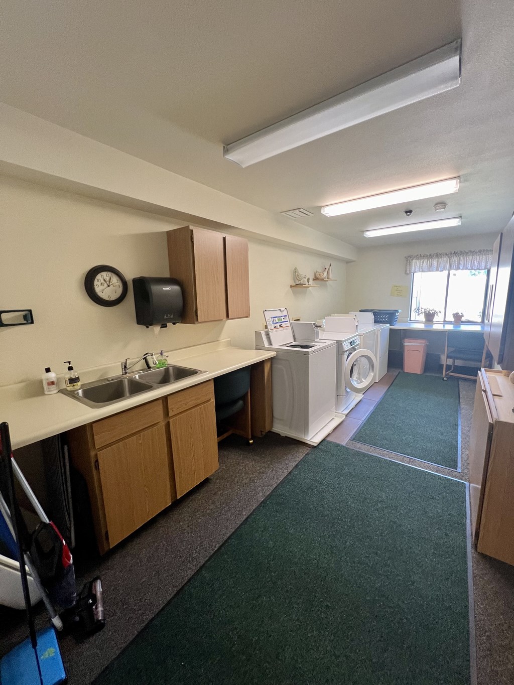 a kitchen with a washer and dryer and a sink