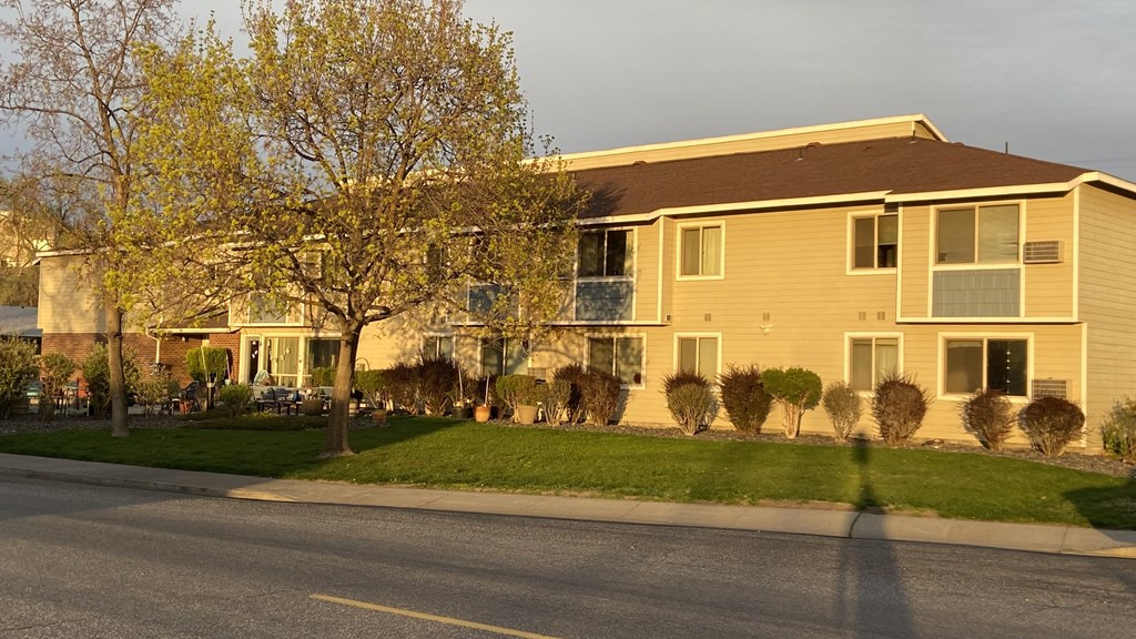 a woman walking down the street in front of a house
