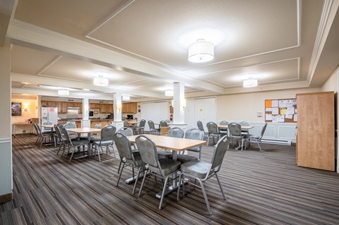 A conference room with a long table and chairs.