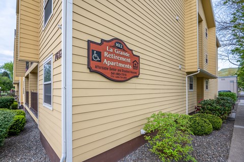A building with a sign that says La Retirement Apartments.