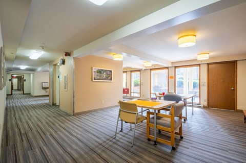 A room with a long table and chairs.