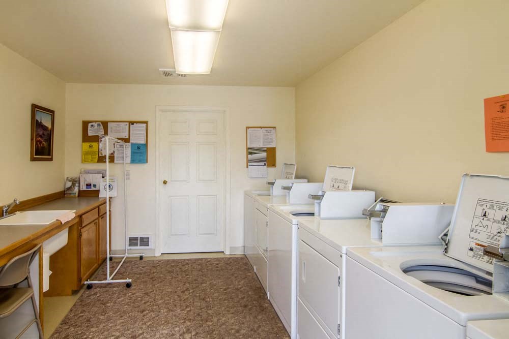 a laundry room with washes and dryers and a sink