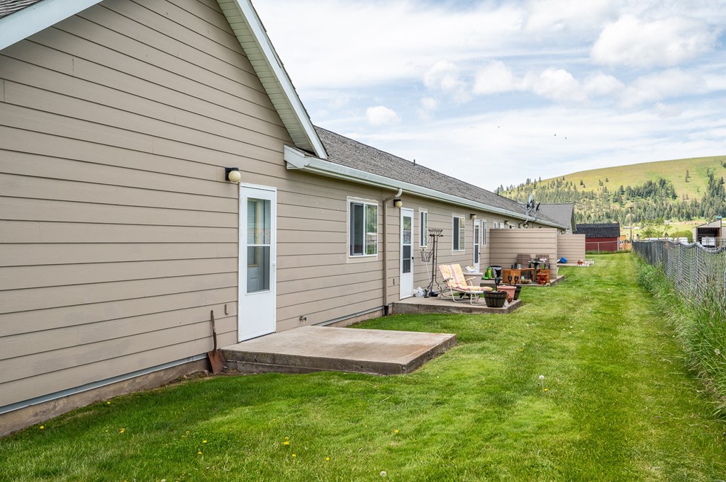 A house with a brown siding and a white door is shown.