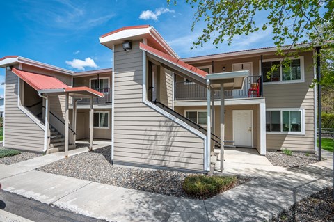 an exterior view of a building with stairs and a driveway