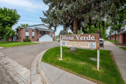 A sign for Mesa Verde in front of a building.