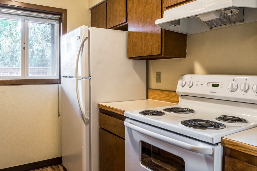 a kitchen with a stove and a refrigerator