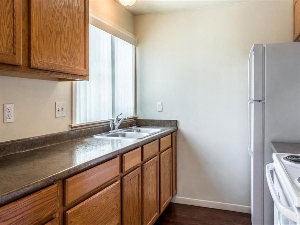 a kitchen with a sink and a refrigerator