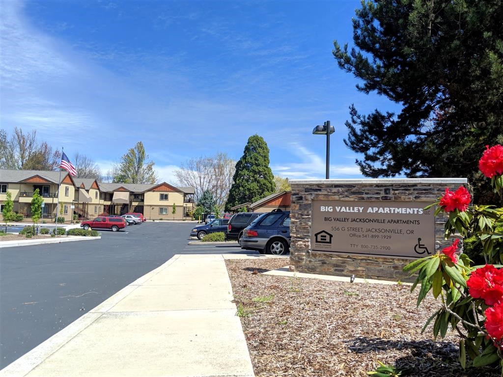 the sign for the administration building in front of a parking lot