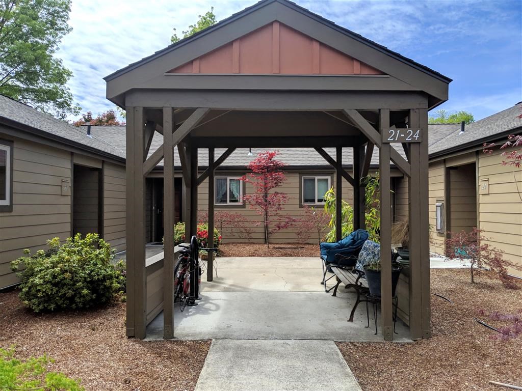 a gazebo with a patio in front of a house