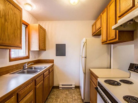 a kitchen with a stove sink and refrigerator