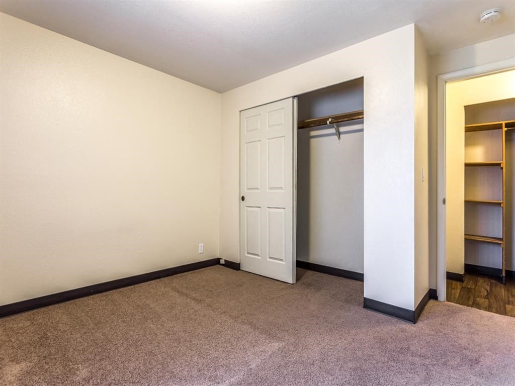 an empty room with a closet and a door
