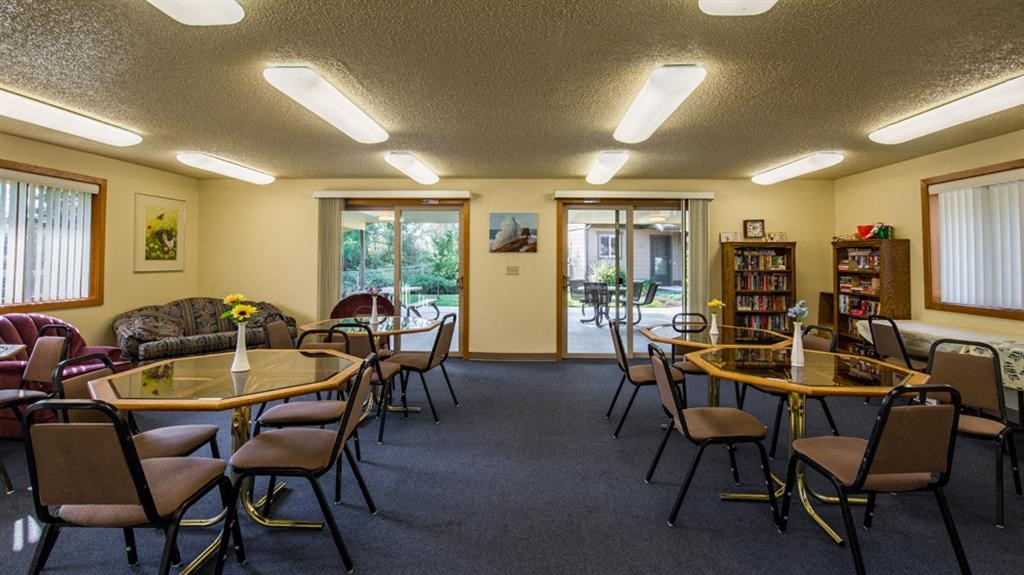 a conference room with tables and chairs and a fireplace