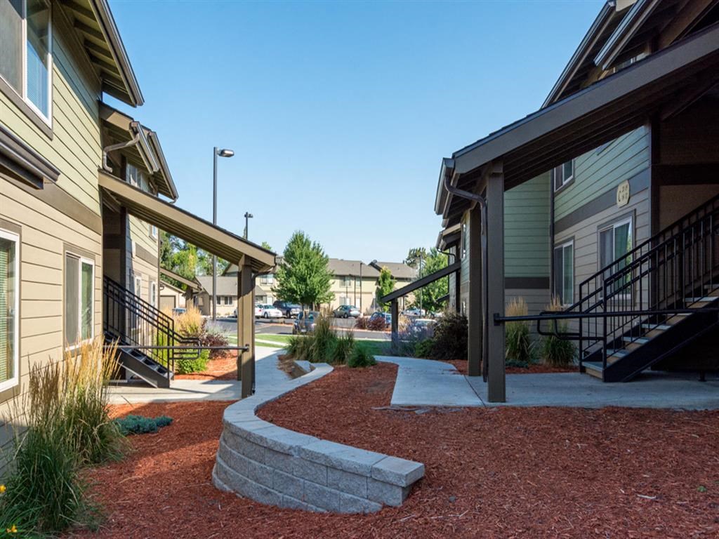 a view of a building with stairs and a sidewalk