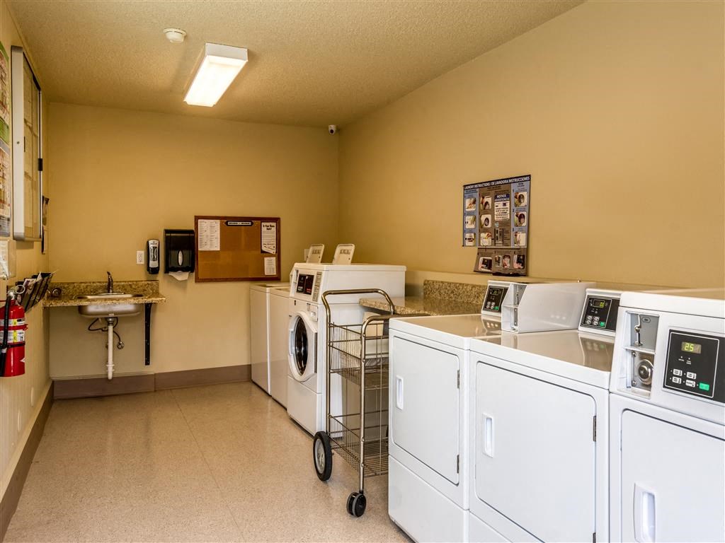 a laundry room with washes and dryers and a sink