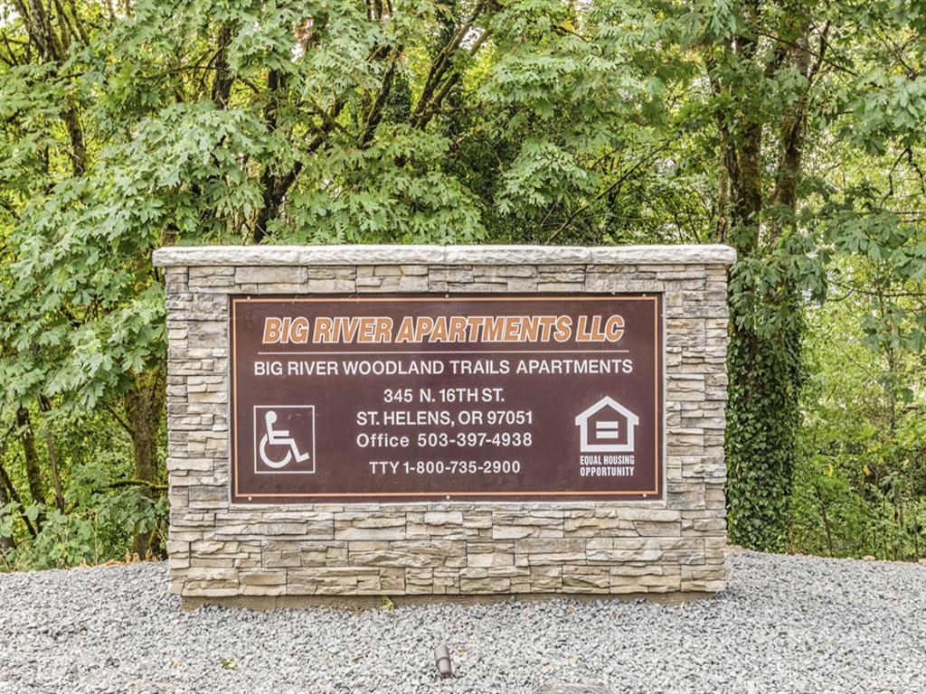 a sign for the big river woodlands apartments llc