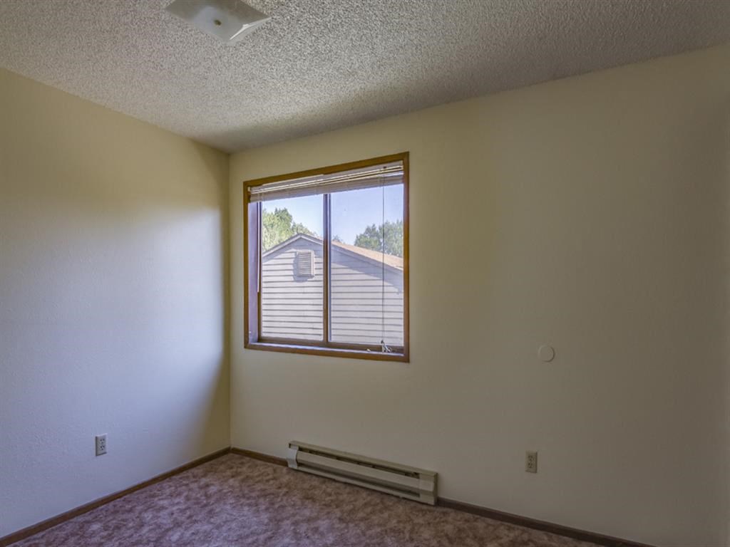 the living room of an empty house with a window