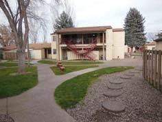a building with a yard and sidewalk in front of it