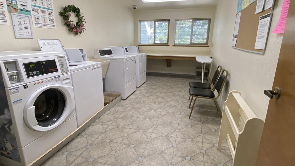 a laundry room with washers and dryers
