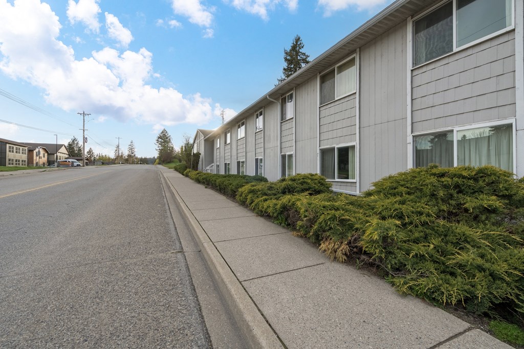 A long residential street with houses on both sides.