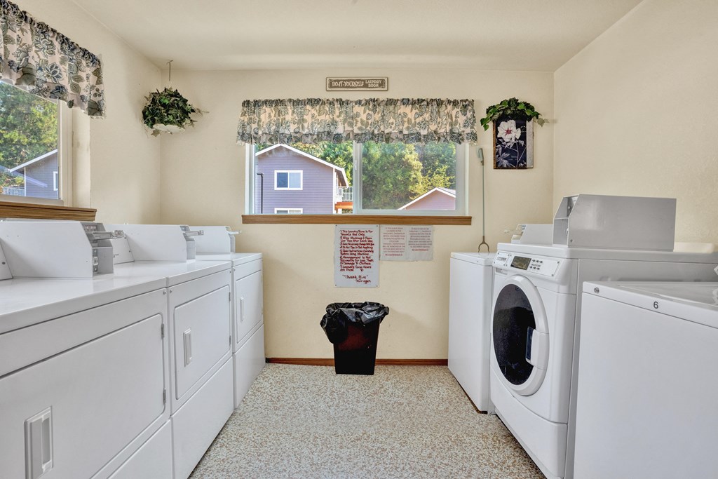a washer and dryer in a laundry room with a window