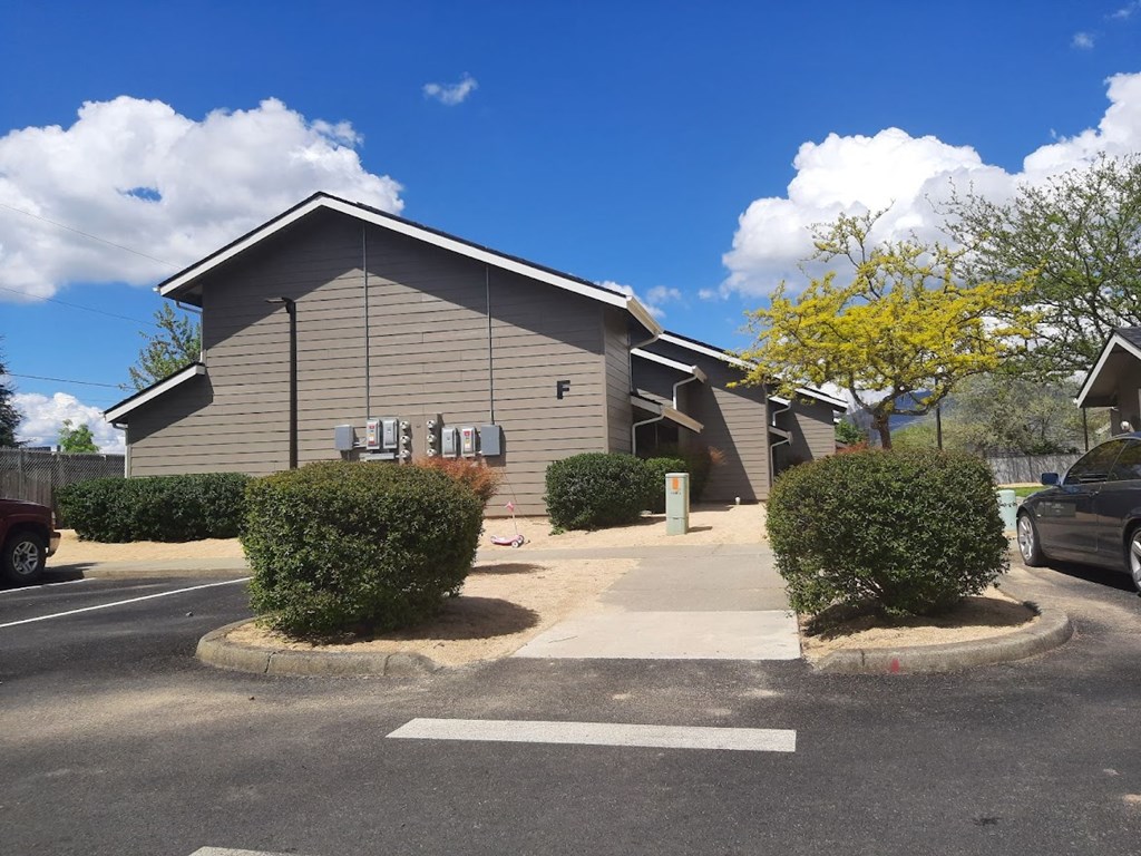 a gray building with a blue sky in the background