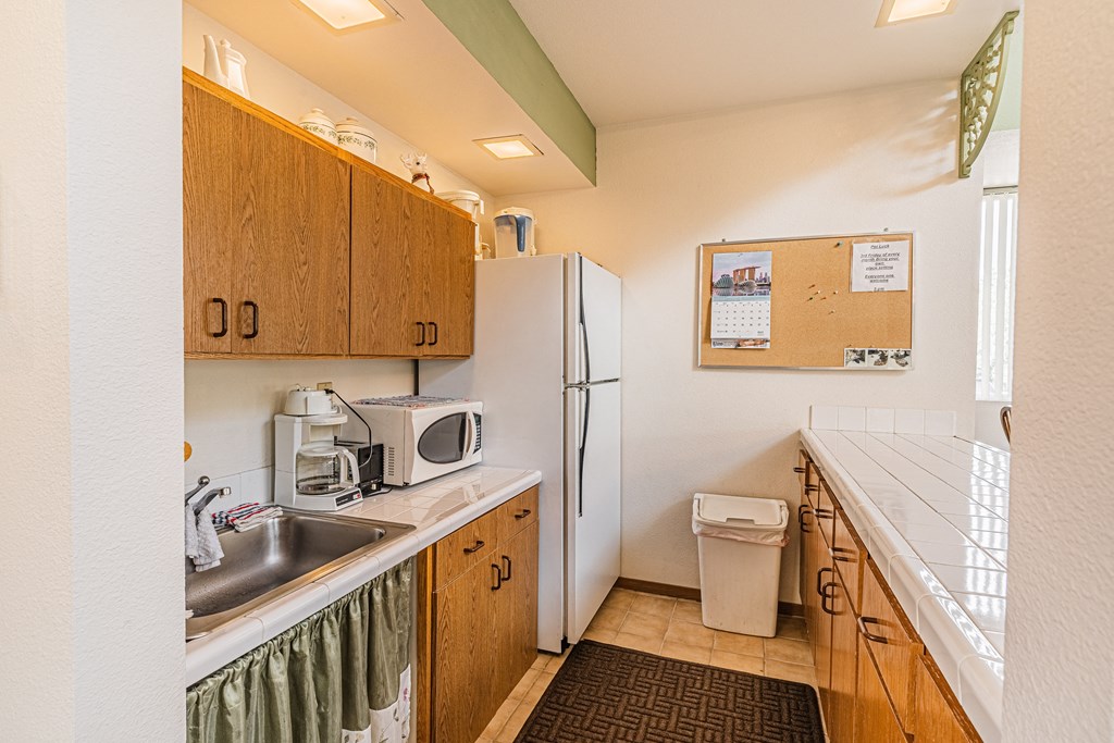 a small kitchen with a sink and a refrigerator