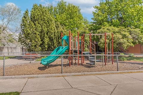 a playground with a slide at a park