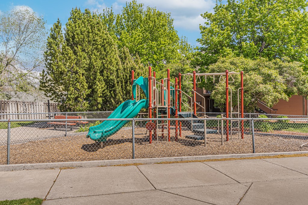 a playground with a slide at a park
