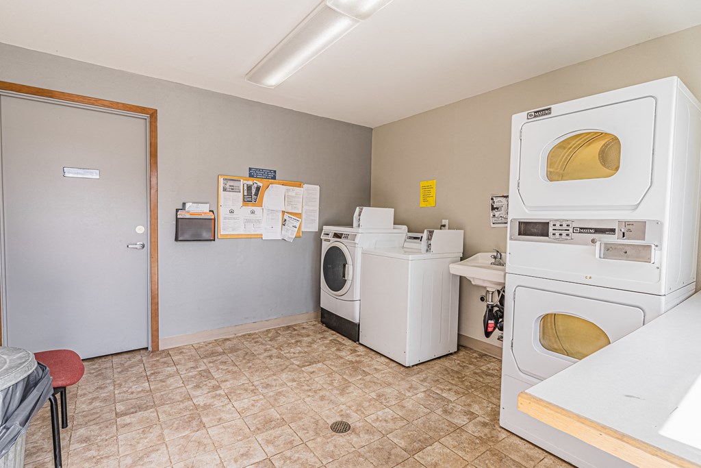 a laundry room with two washes and two washing machines