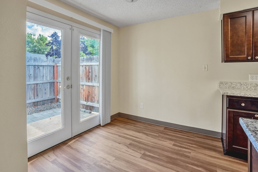 an empty living room with sliding glass doors to a patio