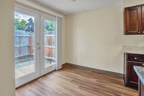 an empty living room with sliding glass doors to a patio