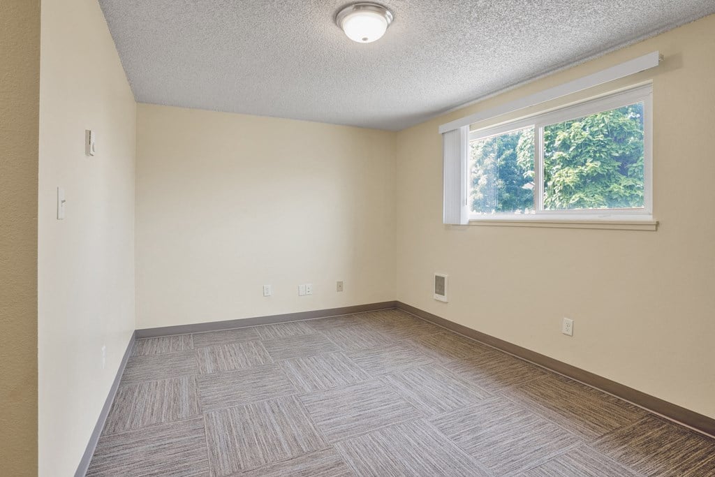 the living room of an empty house with a window